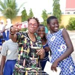 Miss Melannie Denise Cunningham taking a picture with some of the Yendi Youth Connect Young Achievers Club members